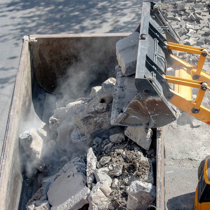 concrete debris being removed by front loader